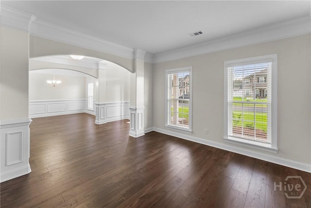 106 Kenwood Cir, Savannah, GA 31302 - unfurnished room with arched walkways, dark wood finished floors, crown molding, a chandelier, and a wainscoted wall