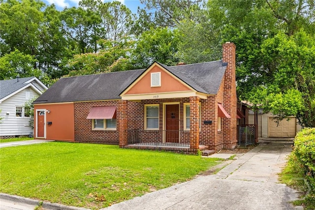 1419 E 35th St, Savannah, GA 31404 - bungalow featuring a chimney, a front lawn, concrete driveway, covered porch, and a shingled roof