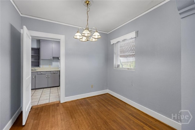 1419 E 35th St, Savannah, GA 31404 - unfurnished dining area with ornamental molding, a chandelier, and hardwood / wood-style floors