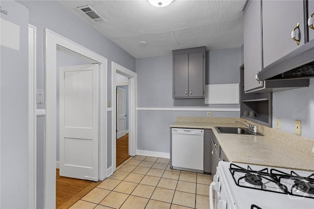 1419 E 35th St, Savannah, GA 31404 - kitchen featuring white appliances, gray cabinetry, light countertops, a textured ceiling, and light tile patterned floors