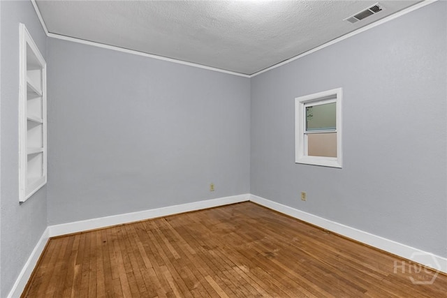 1419 E 35th St, Savannah, GA 31404 - unfurnished room with hardwood / wood-style flooring, ornamental molding, and a textured ceiling