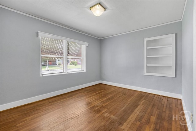 1419 E 35th St, Savannah, GA 31404 - unfurnished room with built in features, wood-type flooring, and ornamental molding