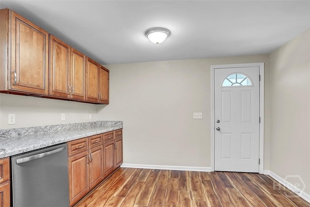 142 Bill Brown Rd, Pembroke, GA 31321 - kitchen with stainless steel dishwasher, dark wood-style flooring, brown cabinets, and light countertops