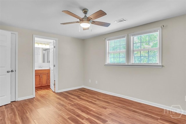 142 Bill Brown Rd, Pembroke, GA 31321 - unfurnished bedroom with light wood-type flooring, ceiling fan, and ensuite bathroom