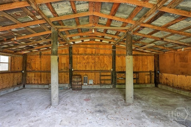 142 Bill Brown Rd, Pembroke, GA 31321 - misc room featuring a garage, vaulted ceiling, and concrete flooring