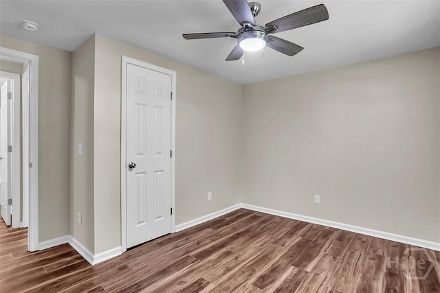 142 Bill Brown Rd, Pembroke, GA 31321 - unfurnished bedroom featuring dark wood-style floors and a ceiling fan