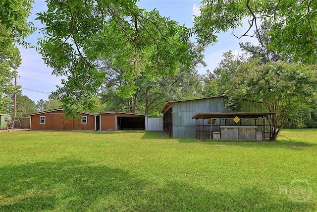 142 Bill Brown Rd, Pembroke, GA 31321 - view of grassy yard with an outbuilding and a carport