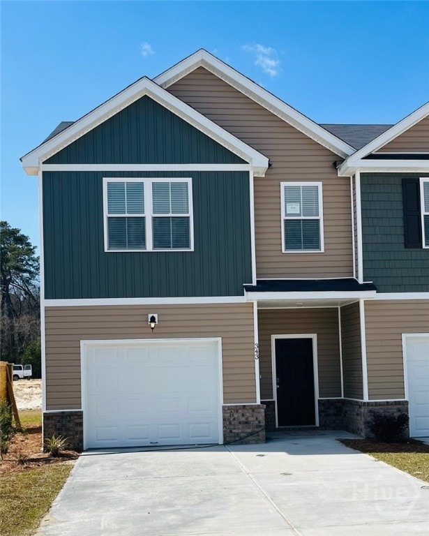343 Governor Gwinnett Way, Pooler, GA 31322 - view of front of property with an attached garage, stone siding, driveway, and board and batten siding
