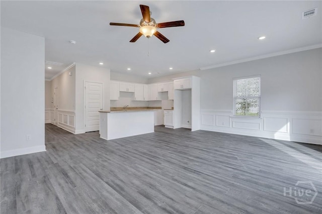343 Governor Gwinnett Way, Pooler, GA 31322 - unfurnished living room featuring ornamental molding, ceiling fan, wood finished floors, recessed lighting, and a wainscoted wall