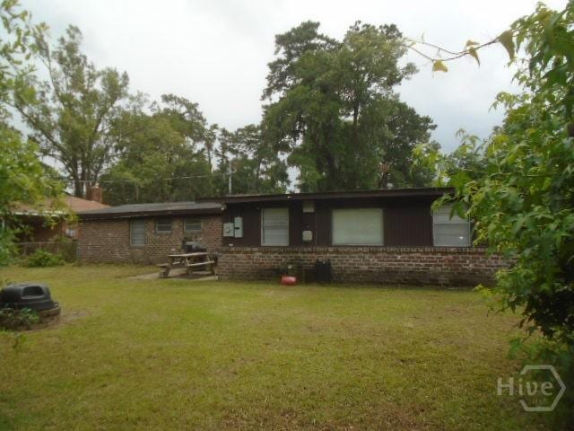 506 Mclaws St, Savannah, GA 31405 - back of property featuring a lawn and brick siding