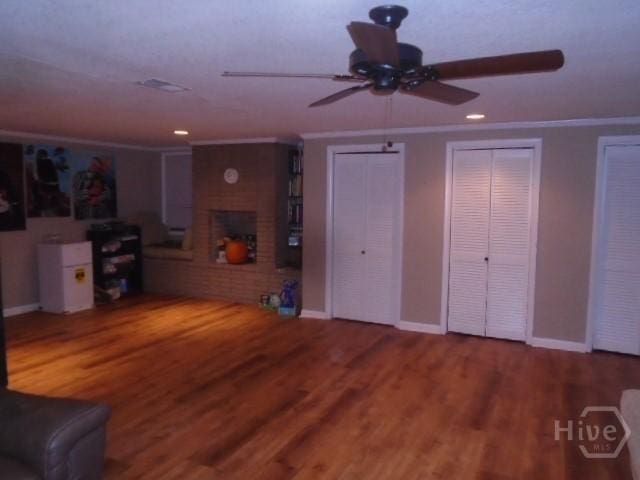 506 Mclaws St, Savannah, GA 31405 - living area featuring ceiling fan, ornamental molding, a brick fireplace, baseboards, and wood finished floors