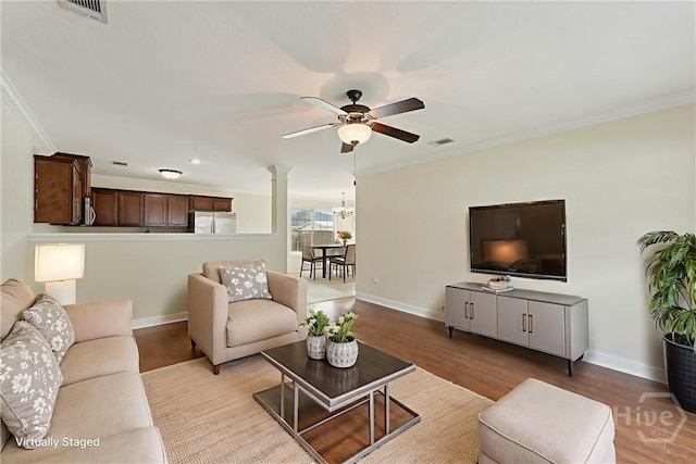 27 Drayton Ct, Midway, GA 31320 - living area featuring ceiling fan, baseboards, ornamental molding, decorative columns, and wood finished floors
