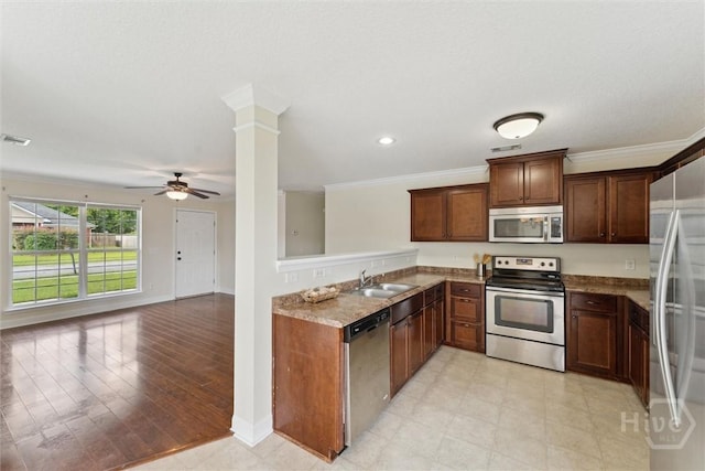 27 Drayton Ct, Midway, GA 31320 - kitchen featuring stainless steel appliances, a sink, a ceiling fan, crown molding, and baseboards