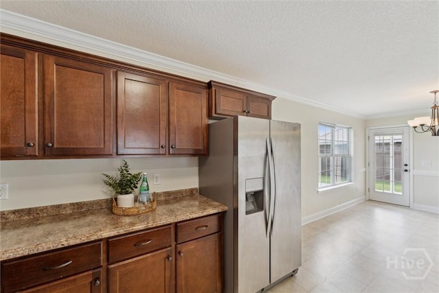 27 Drayton Ct, Midway, GA 31320 - kitchen with stainless steel fridge, crown molding, a chandelier, a textured ceiling, and baseboards