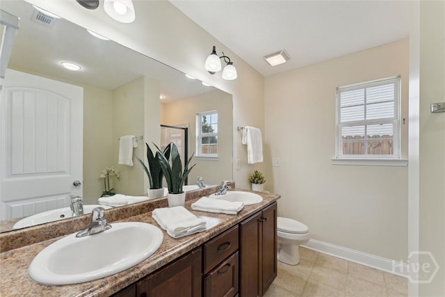 27 Drayton Ct, Midway, GA 31320 - full bath featuring baseboards, double vanity, toilet, an enclosed shower, and tile patterned floors