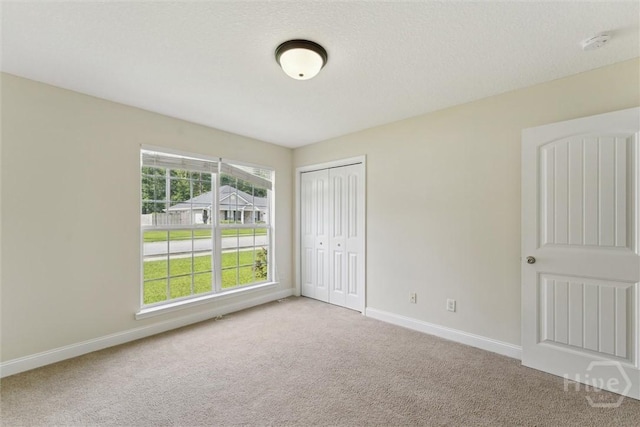 27 Drayton Ct, Midway, GA 31320 - unfurnished bedroom featuring carpet, baseboards, and a closet
