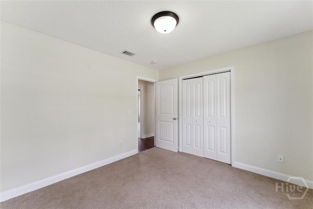 27 Drayton Ct, Midway, GA 31320 - unfurnished bedroom with carpet flooring, baseboards, and a closet