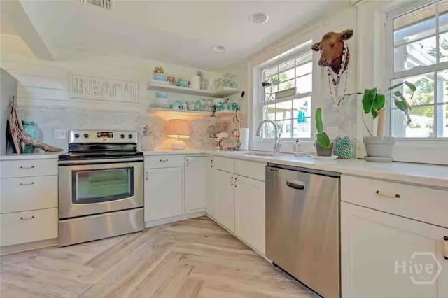 1810 Chatham Ave, Tybee Island, GA 31328 - kitchen featuring stainless steel appliances, plenty of natural light, a sink, and light countertops