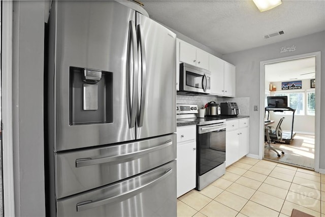1346 Ryans Way, Pooler, GA 31322 - kitchen with stainless steel appliances, dark countertops, white cabinetry, decorative backsplash, and light tile patterned flooring