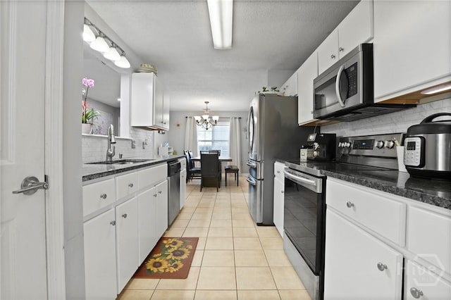 1346 Ryans Way, Pooler, GA 31322 - kitchen featuring stainless steel appliances, a sink, white cabinets, backsplash, and light tile patterned flooring