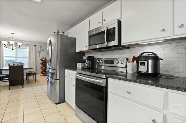 1346 Ryans Way, Pooler, GA 31322 - kitchen featuring appliances with stainless steel finishes, a chandelier, white cabinetry, tasteful backsplash, and light tile patterned flooring