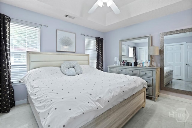 1346 Ryans Way, Pooler, GA 31322 - bedroom featuring multiple windows, a raised ceiling, light tile patterned flooring, and ceiling fan