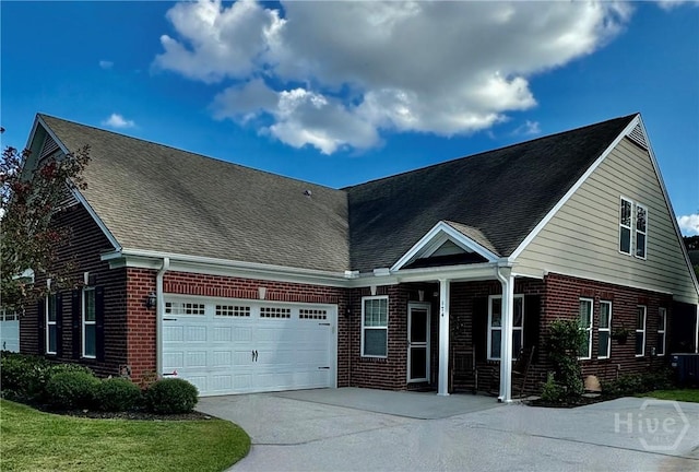 174 Regency Cir, Pooler, GA 31322 - view of front facade with brick siding, a garage, concrete driveway, and roof with shingles