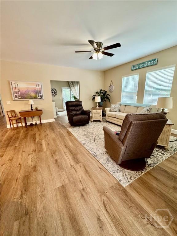 174 Regency Cir, Pooler, GA 31322 - living area with wood finished floors, a ceiling fan, and baseboards