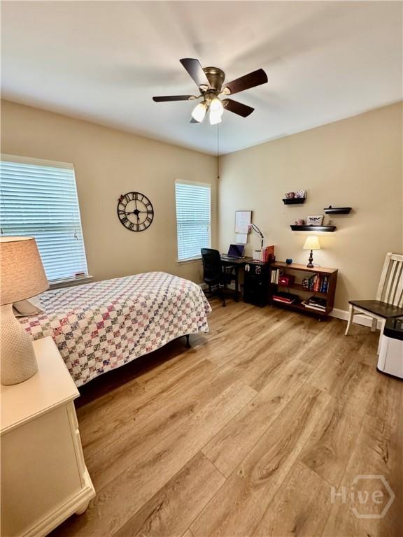 174 Regency Cir, Pooler, GA 31322 - bedroom featuring light wood-type flooring, ceiling fan, and baseboards