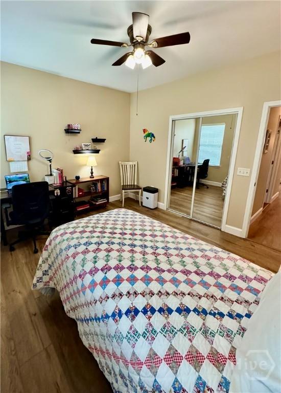 174 Regency Cir, Pooler, GA 31322 - bedroom with wood finished floors, baseboards, a desk, and a closet