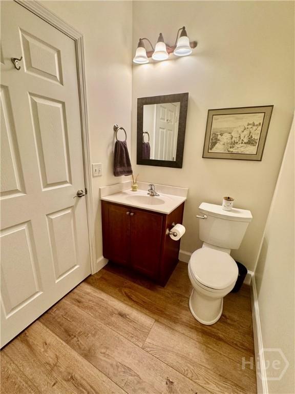 174 Regency Cir, Pooler, GA 31322 - bathroom with wood finished floors, vanity, baseboards, and toilet