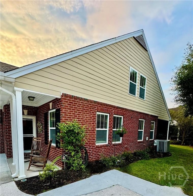 174 Regency Cir, Pooler, GA 31322 - view of property exterior with brick siding, cooling unit, a yard, and a porch