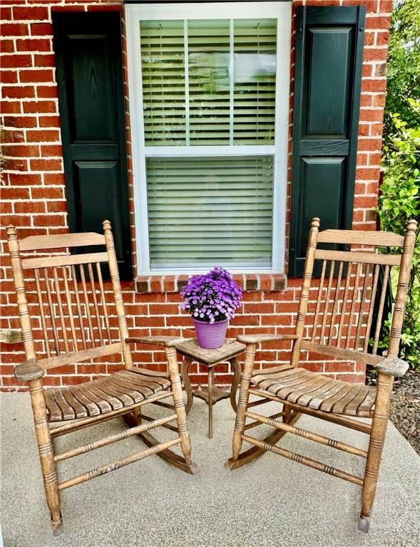 174 Regency Cir, Pooler, GA 31322 - view of exterior entry featuring brick siding and covered porch