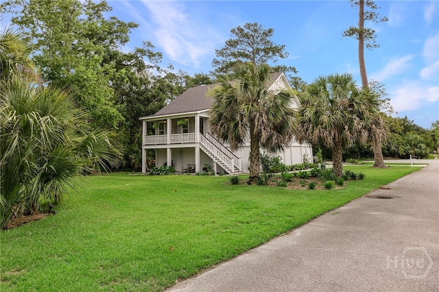 122 N St, Savannah, GA 31410 - coastal home with stairway, a front lawn, and covered porch