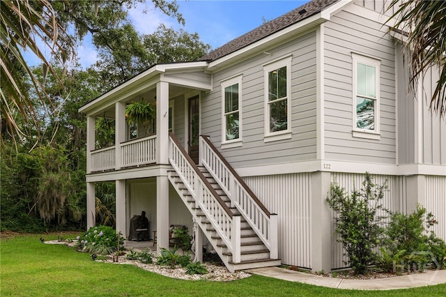 122 N St, Savannah, GA 31410 - rear view of house with stairway, a yard, covered porch, and a shingled roof