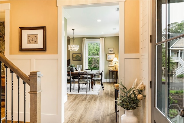 122 N St, Savannah, GA 31410 - hall featuring light wood-type flooring, a decorative wall, ornamental molding, stairway, and recessed lighting