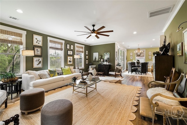 122 N St, Savannah, GA 31410 - living area with crown molding, wood finished floors, recessed lighting, a chandelier, and a ceiling fan