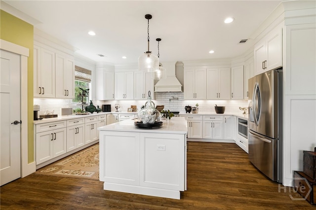 122 N St, Savannah, GA 31410 - kitchen with stainless steel fridge, custom exhaust hood, light countertops, white cabinetry, and recessed lighting