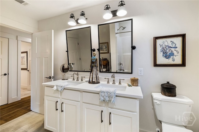 122 N St, Savannah, GA 31410 - full bath featuring double vanity, toilet, and wood finished floors