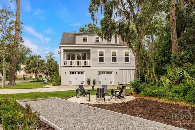 122 N St, Savannah, GA 31410 - rear view of house with an attached garage, concrete driveway, and a balcony