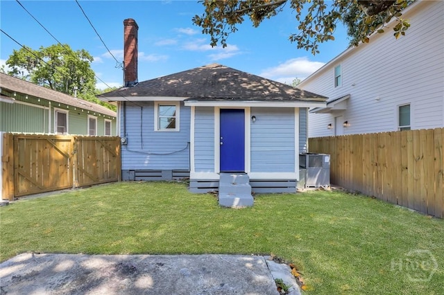 521 Seiler Ave, Savannah, GA 31401 - back of house featuring entry steps, a shingled roof, a chimney, and a gate