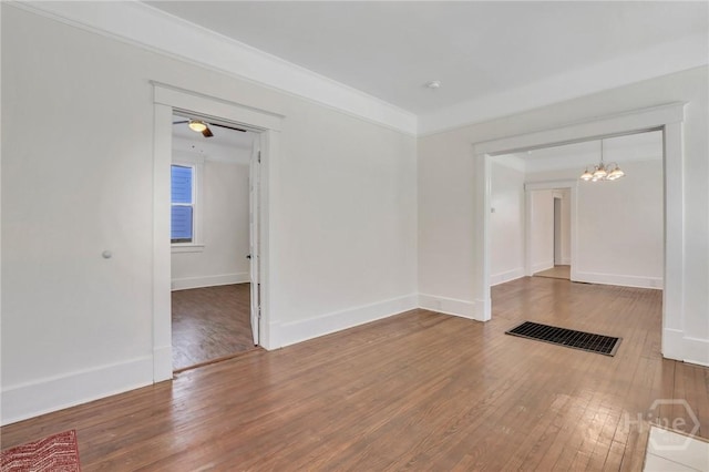 521 Seiler Ave, Savannah, GA 31401 - unfurnished room featuring hardwood / wood-style flooring, a chandelier, and baseboards