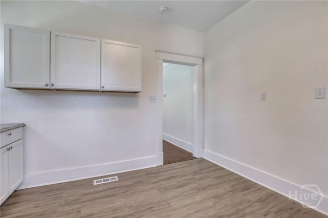 521 Seiler Ave, Savannah, GA 31401 - unfurnished dining area with light wood-type flooring and baseboards
