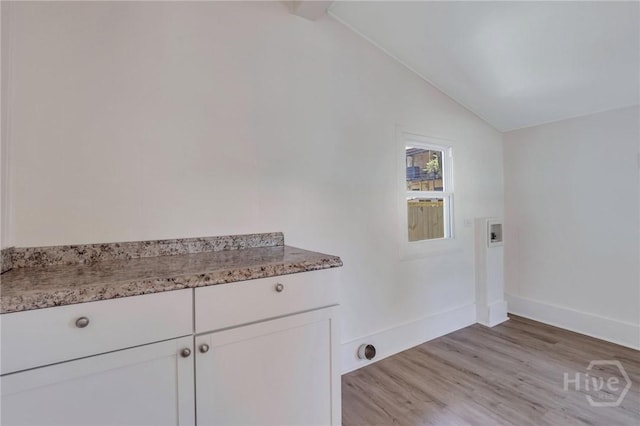 521 Seiler Ave, Savannah, GA 31401 - washroom featuring cabinet space, washer hookup, light wood-style flooring, and baseboards
