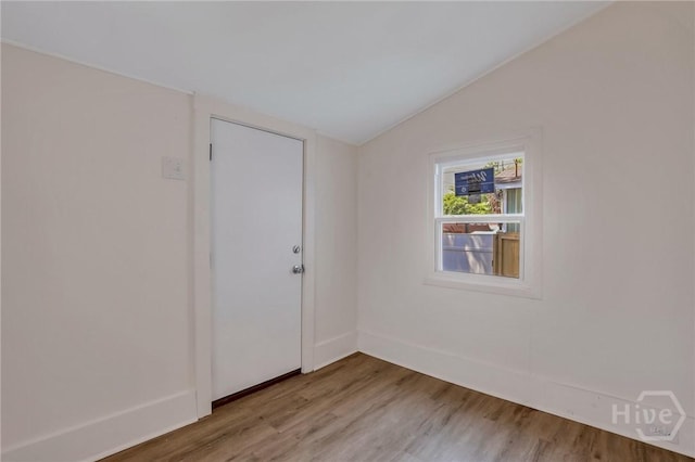 521 Seiler Ave, Savannah, GA 31401 - empty room with vaulted ceiling, wood finished floors, and baseboards