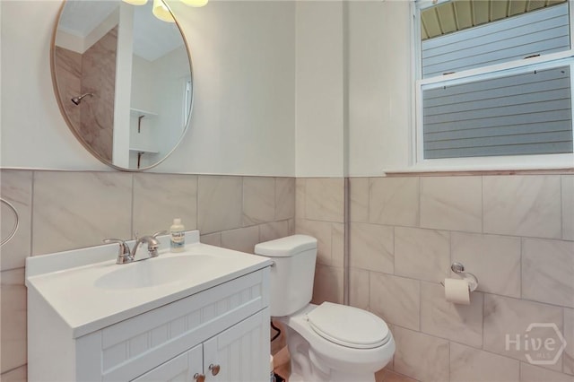 521 Seiler Ave, Savannah, GA 31401 - half bathroom featuring tile walls, vanity, and toilet