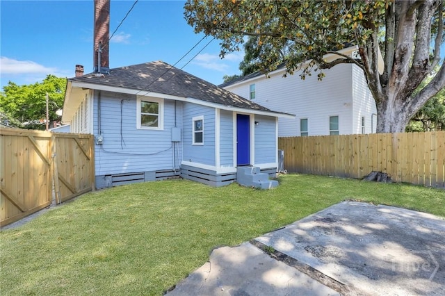 521 Seiler Ave, Savannah, GA 31401 - back of house featuring roof with shingles, a patio area, and a chimney
