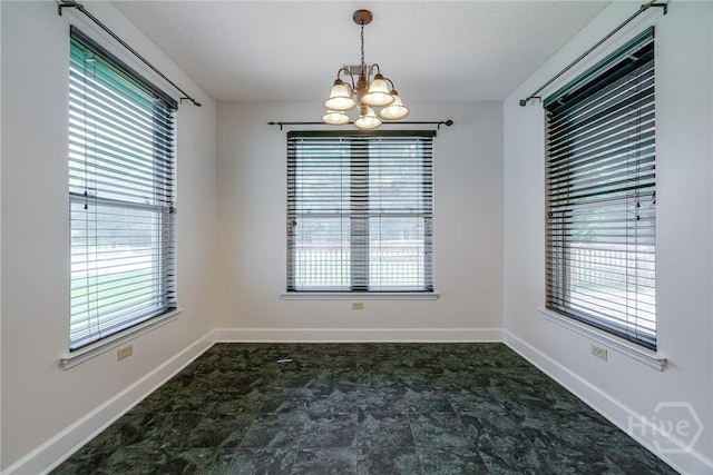 1 Shipyard Ln, Savannah, GA 31406 - empty room featuring a chandelier, healthy amount of natural light, and baseboards