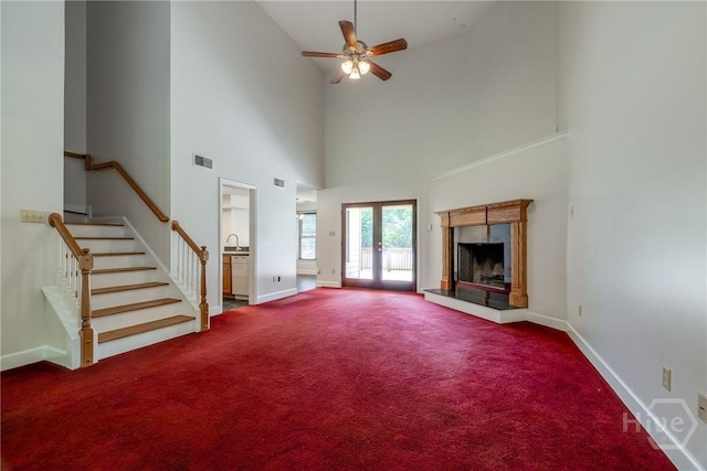 1 Shipyard Ln, Savannah, GA 31406 - unfurnished living room featuring carpet flooring, ceiling fan, a high ceiling, baseboards, and a sink
