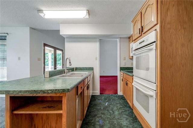 1 Shipyard Ln, Savannah, GA 31406 - kitchen with white double oven, a peninsula, a sink, dark countertops, and a textured ceiling